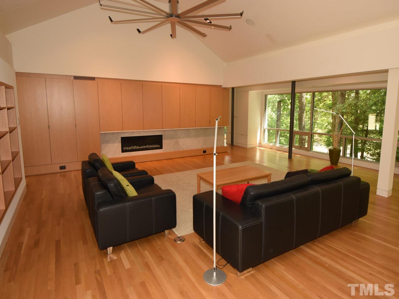 2109 St James Road Raleigh, NC 27607 - Photo 6 of 25 a living room with furniture a ceiling fan and a large window