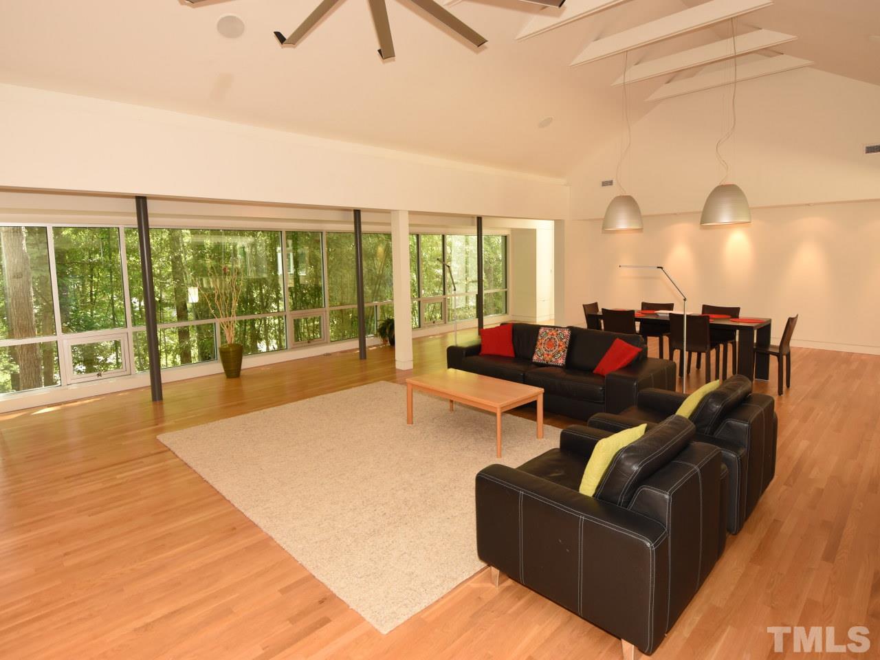 2109 St James Road Raleigh, NC 27607 - Photo 7 of 25 a living room with furniture and a floor to ceiling window