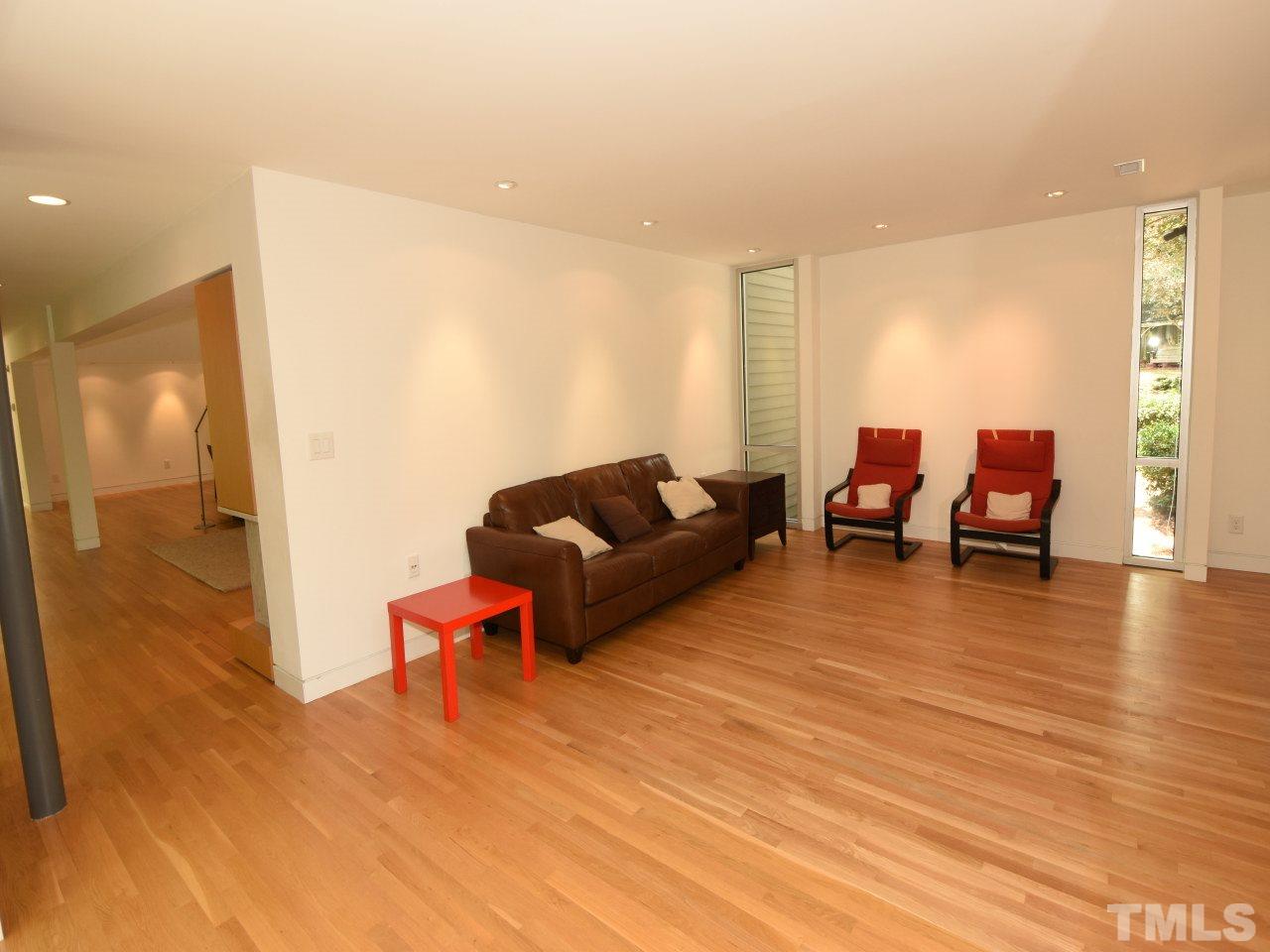 2109 St James Road Raleigh, NC 27607 - Photo 10 of 25 a living room with furniture and wooden floor