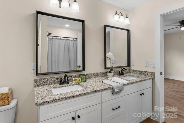 a bathroom with double sink and a mirror