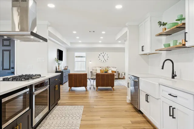 a kitchen with stainless steel appliances granite countertop a stove and a sink