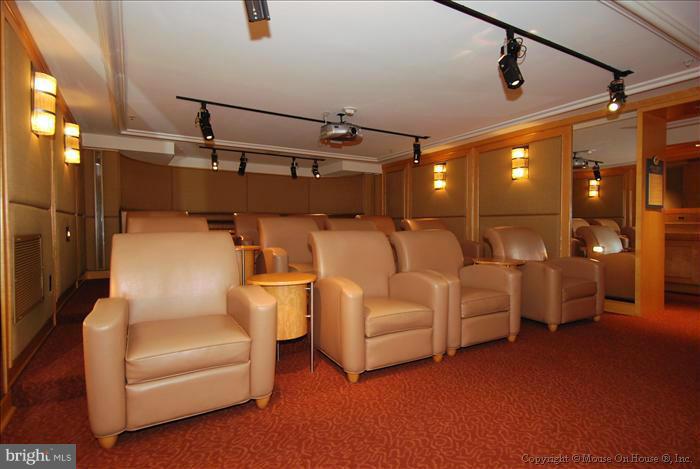 616 E Street Northwest, Unit 1207 Washington, DC 20004 - Photo 22 of 25 a projector room with white walls and furniture