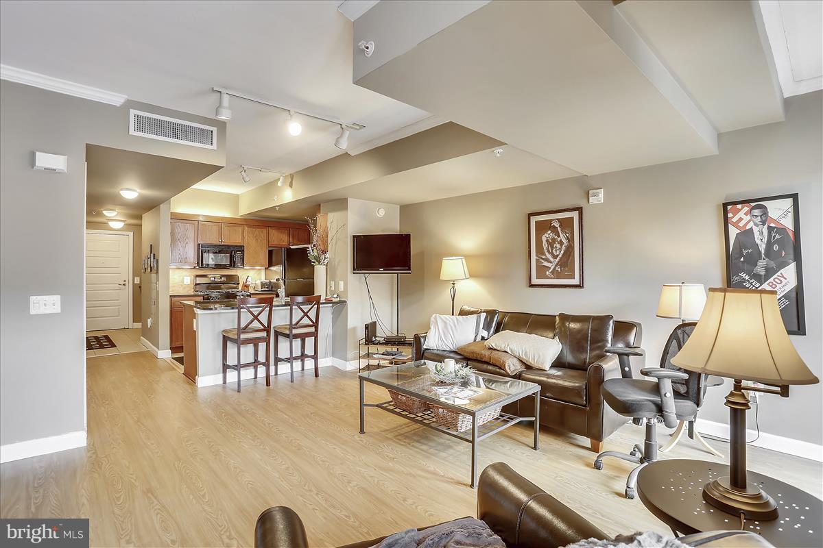 616 E Street Northwest, Unit 1207 Washington, DC 20004 - Photo 5 of 25 a living room with furniture and a table