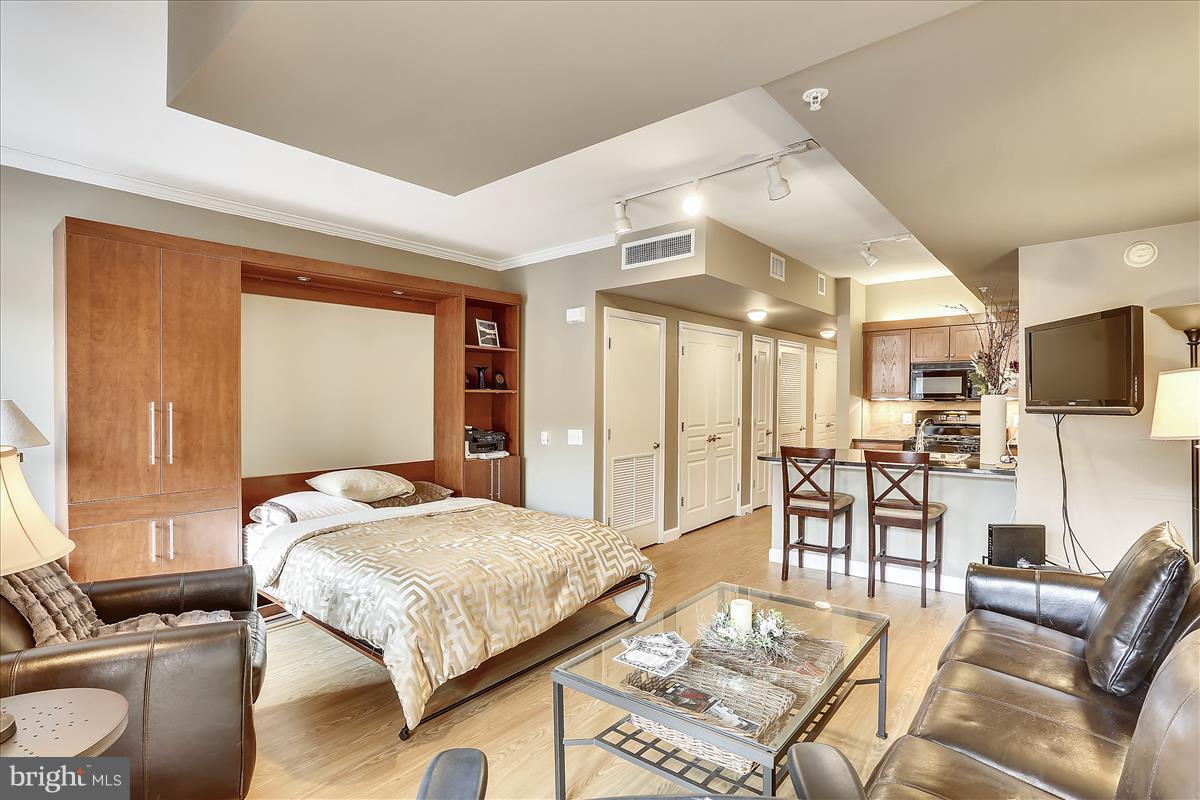 616 E Street Northwest, Unit 1207 Washington, DC 20004 - Photo 7 of 25 a living room with furniture kitchen view and a large window