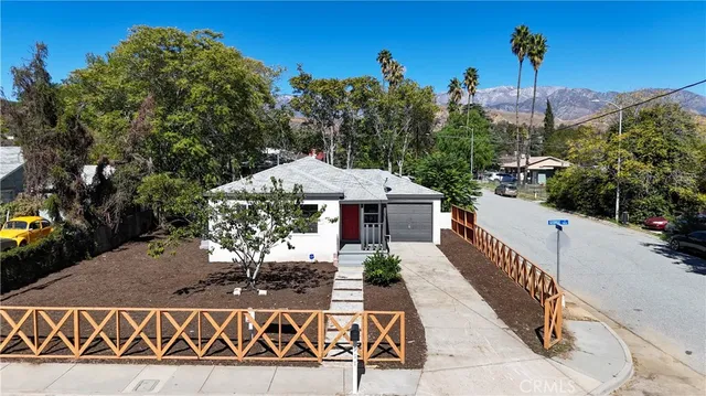 a view of a house with wooden fence