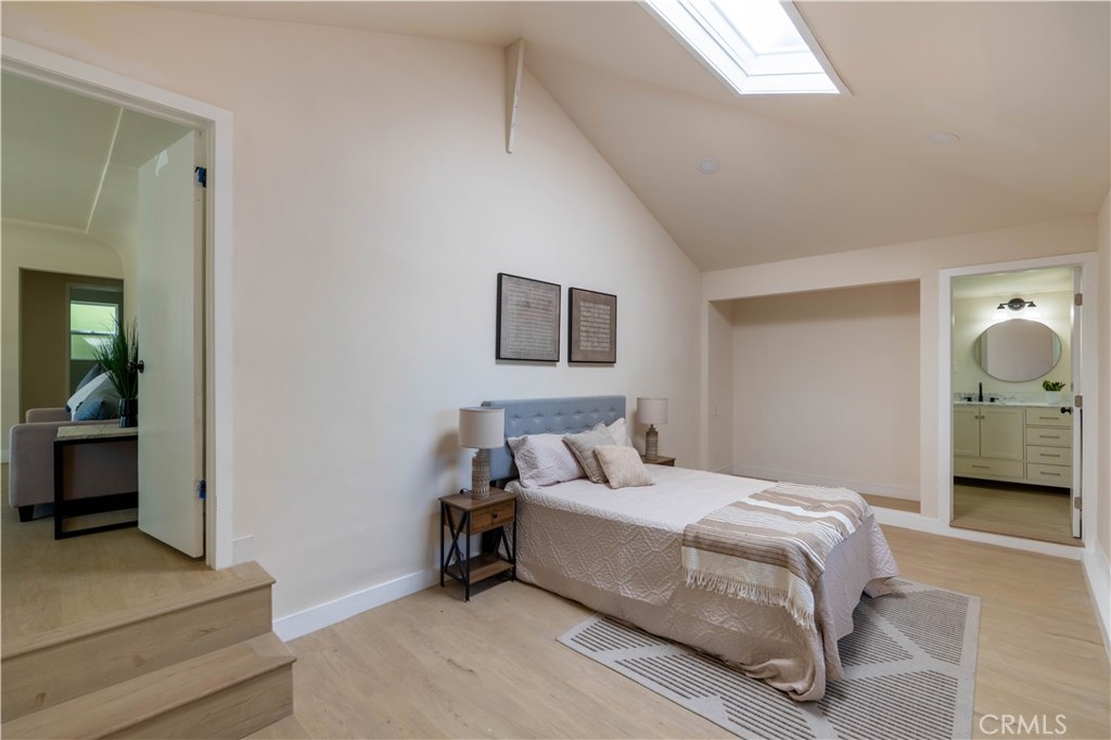 911 West George Street Banning, CA 92220 - Photo 16 of 32 a bedroom with a bed and a view of en suite bathroom