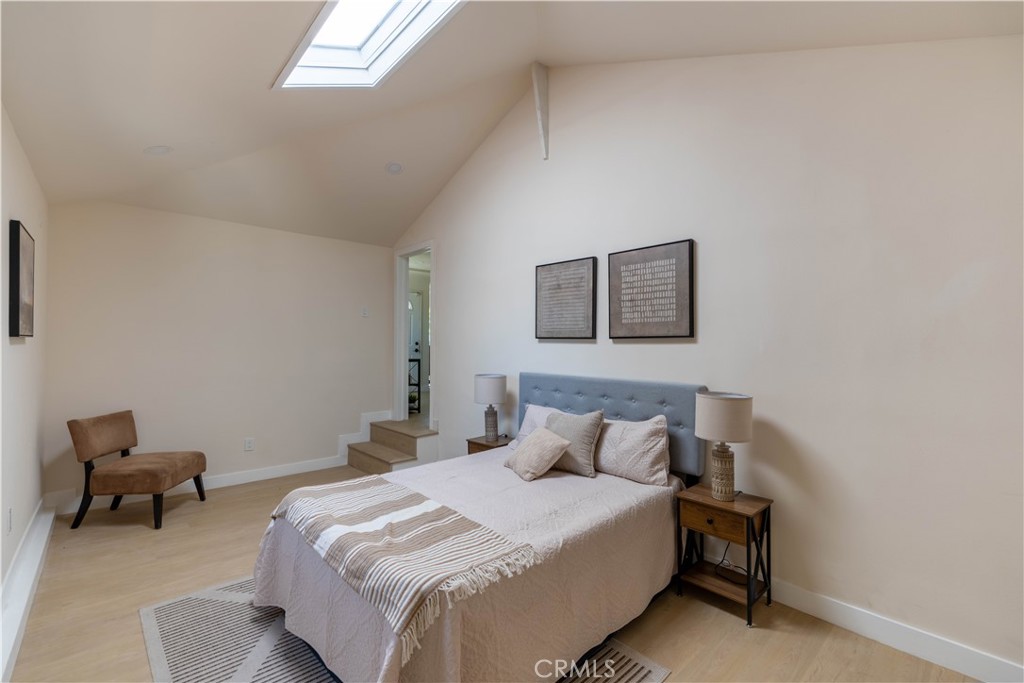 911 West George Street Banning, CA 92220 - Photo 17 of 32 a bedroom with a bed and a chair