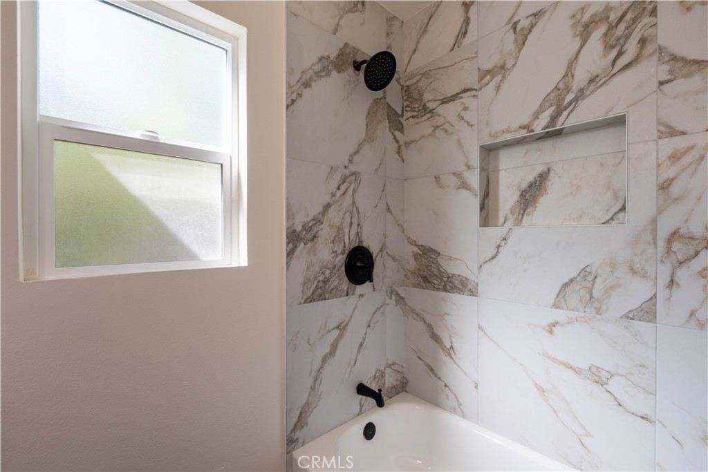 911 West George Street Banning, CA 92220 - Photo 24 of 32 a bathroom with a bathtub and shower