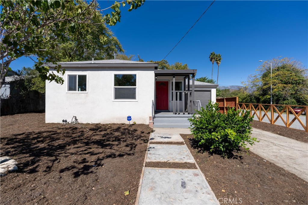 911 West George Street Banning, CA 92220 - Photo 6 of 32 a view of a house with a flower garden