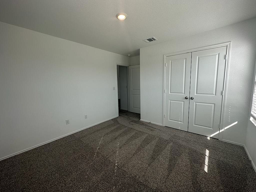 160 River Rise Road Kyle, TX 78640 - Photo 13 of 35 Spacious room featuring neutral carpeting, white walls, and a recessed ceiling light