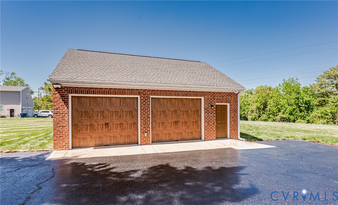 2018 Valentine Road Henrico, VA 23228 - Photo 54 of 65 a front view of a house with a yard and garage