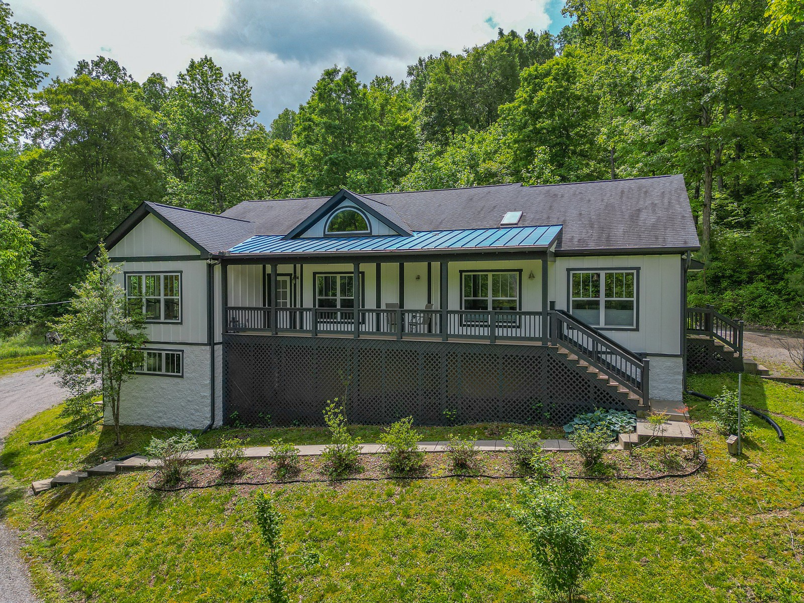 1115 Ridgecrest Road Kingston Springs, TN 37082 - Photo 2 of 38 a front view of a house with a yard table and chairs