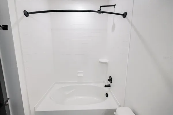 a bathroom with a shower and a bath tub
