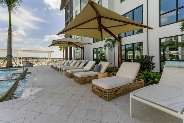 a view of a patio with swimming pool table and chairs