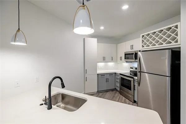 a kitchen with a sink stainless steel appliances and cabinets