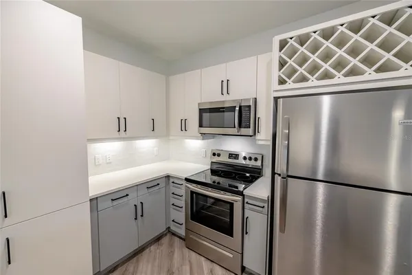 a kitchen with a refrigerator stove and microwave