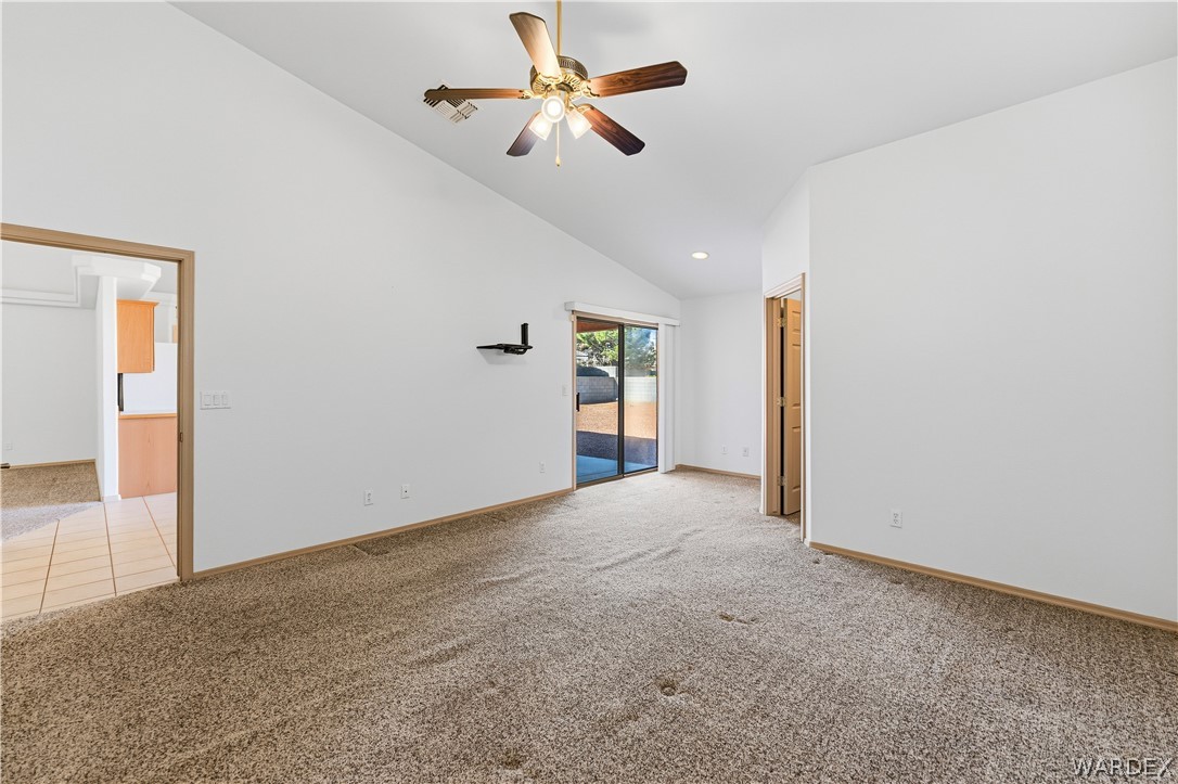 3973 Prairie View Drive Kingman, AZ 86409 - Photo 18 of 34 This spacious room features vaulted ceilings, a ceiling fan with light, and carpeted floors