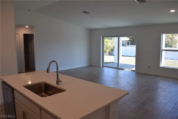 a kitchen with a sink a counter top space and cabinets