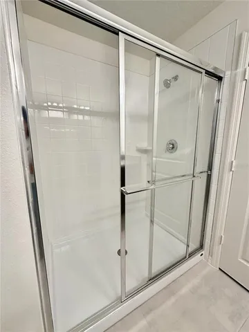 a bathroom with a glass shower door