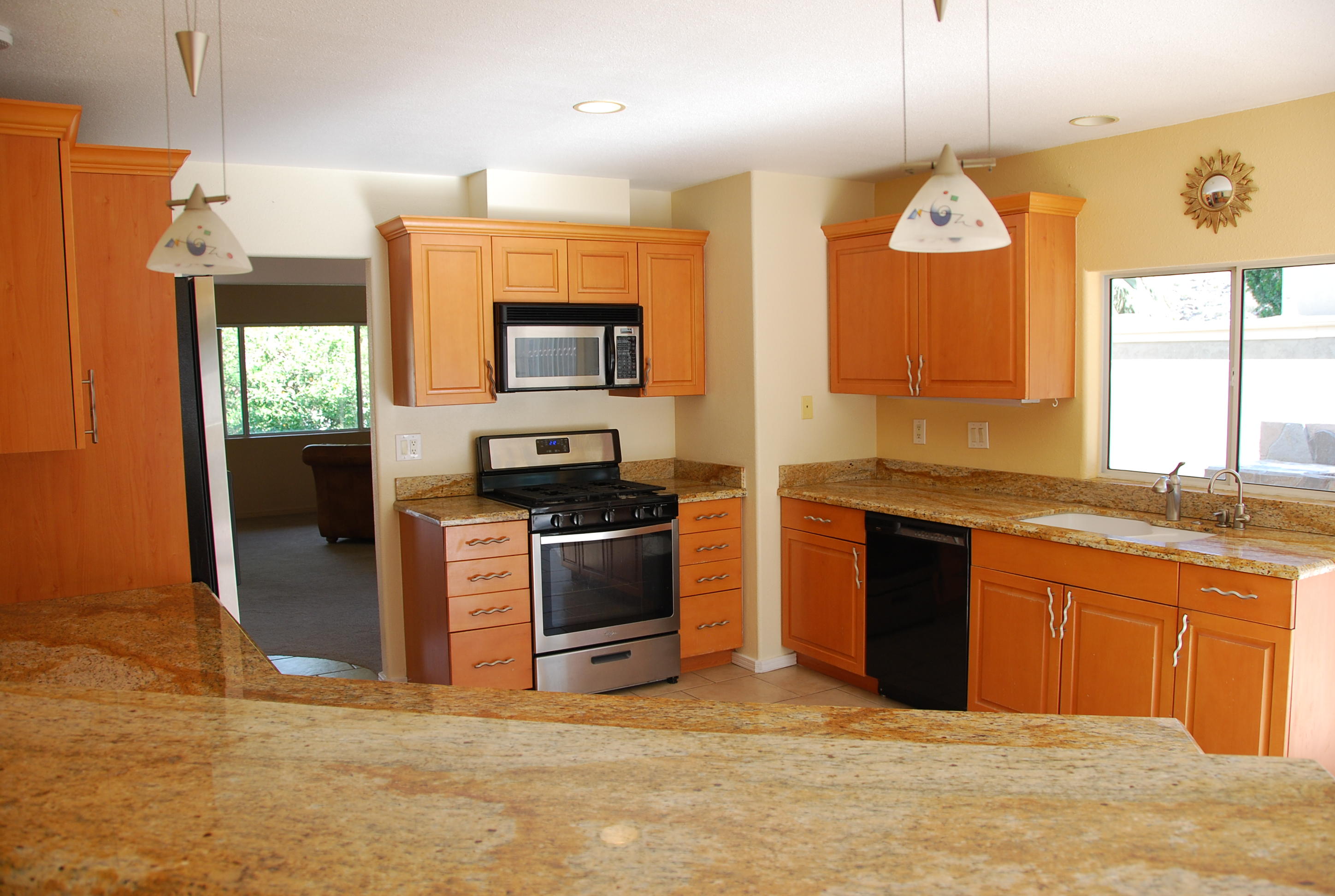 71601 Gardess Road Rancho Mirage, CA 92270 - Photo 2 of 17 a kitchen with stainless steel appliances granite countertop a stove a sink and a refrigerator