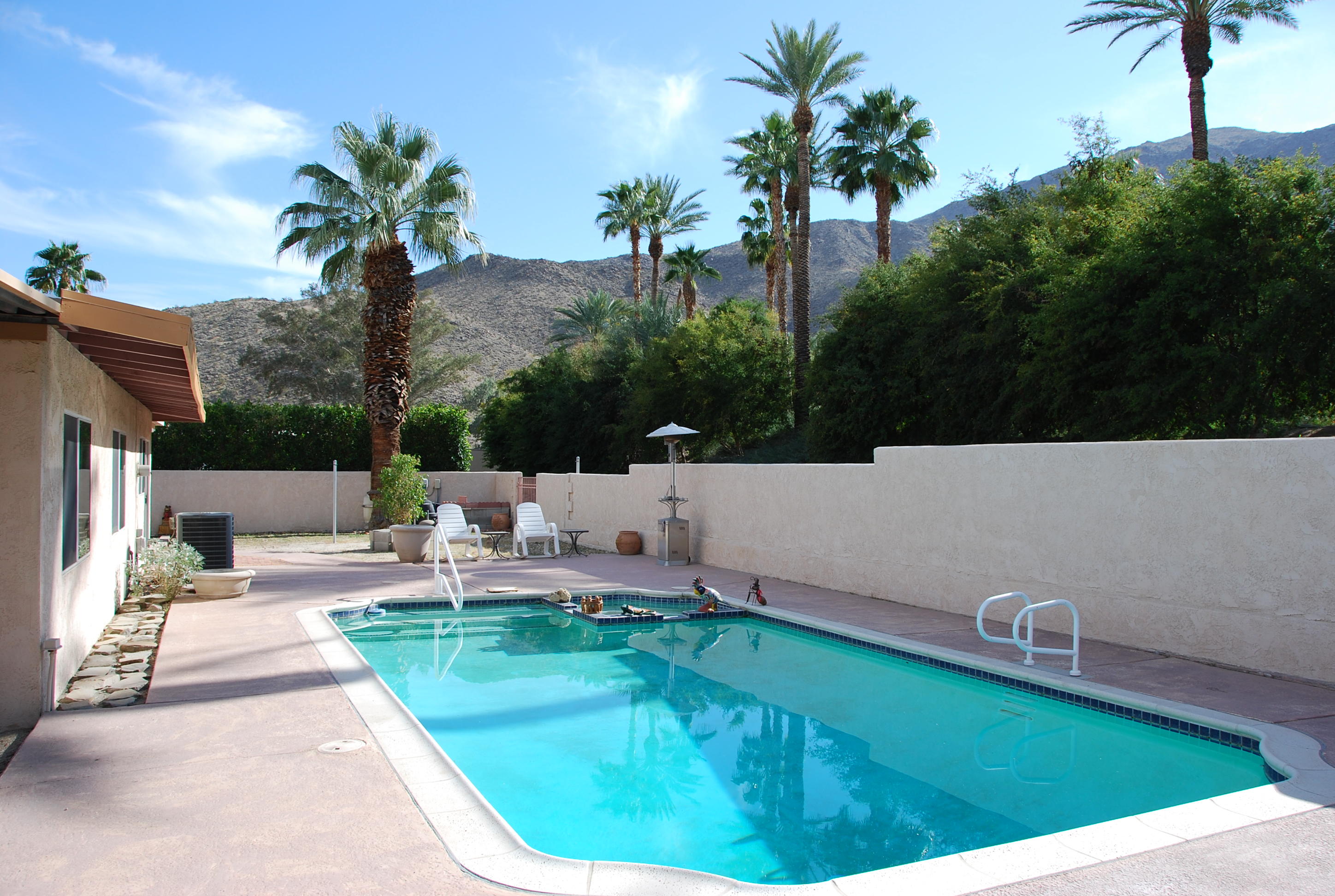 71601 Gardess Road Rancho Mirage, CA 92270 - Photo 3 of 17 a swimming pool with outdoor seating and plants