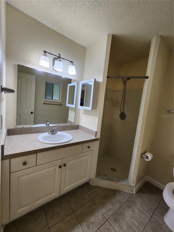 501 Southwest 75th Street, Unit A14 Gainesville, FL 32607 - Photo 37 of 56 a bathroom with a granite countertop sink toilet and mirror