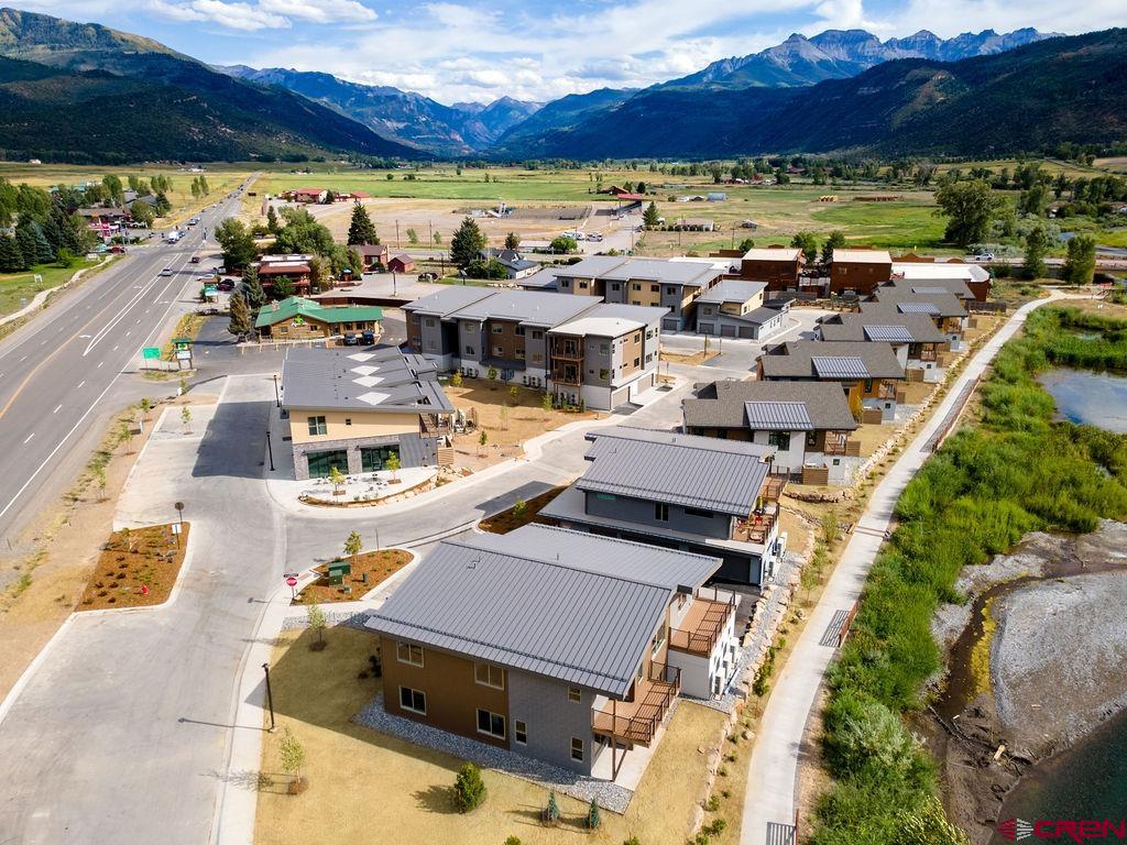199 Riverfront Lane, Unit 201 Ridgway, CO 81432 - Photo 13 of 22 a picture of a city with lots of residential buildings ocean and mountain view in back
