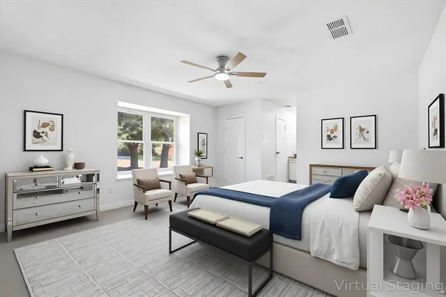 a view of an empty room with a fireplace and a window