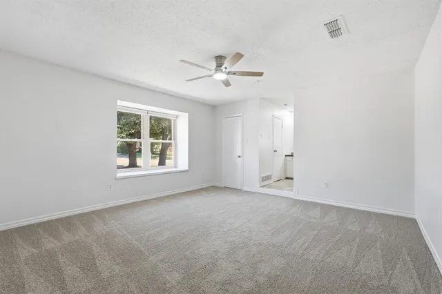 a bedroom with a bed and ceiling fan