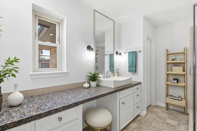 an empty room with a window and a ceiling fan