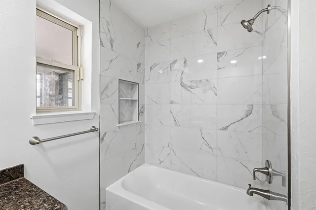 a bathroom with a granite countertop sink and vanity