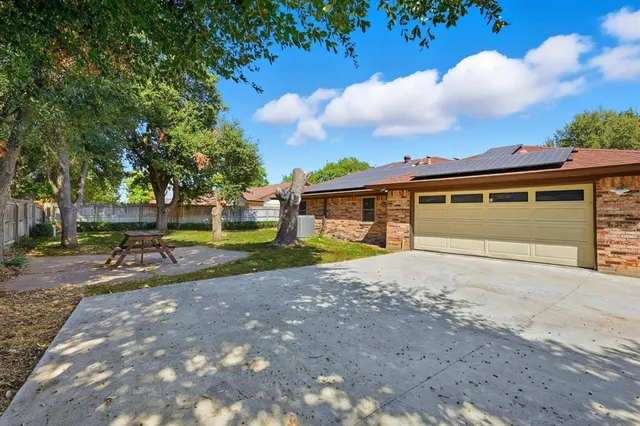 a view of a yard with wooden fence
