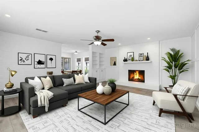 a living room with furniture flower pot and a fireplace