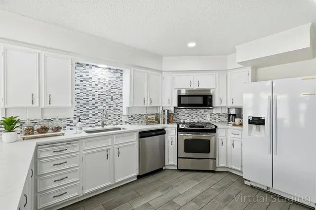 a kitchen with a sink stove and refrigerator