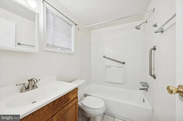 a bathroom with a sink toilet vanity and shower