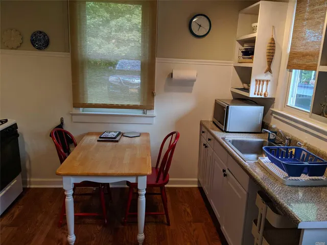 a view of a workspace with furniture and wooden floor