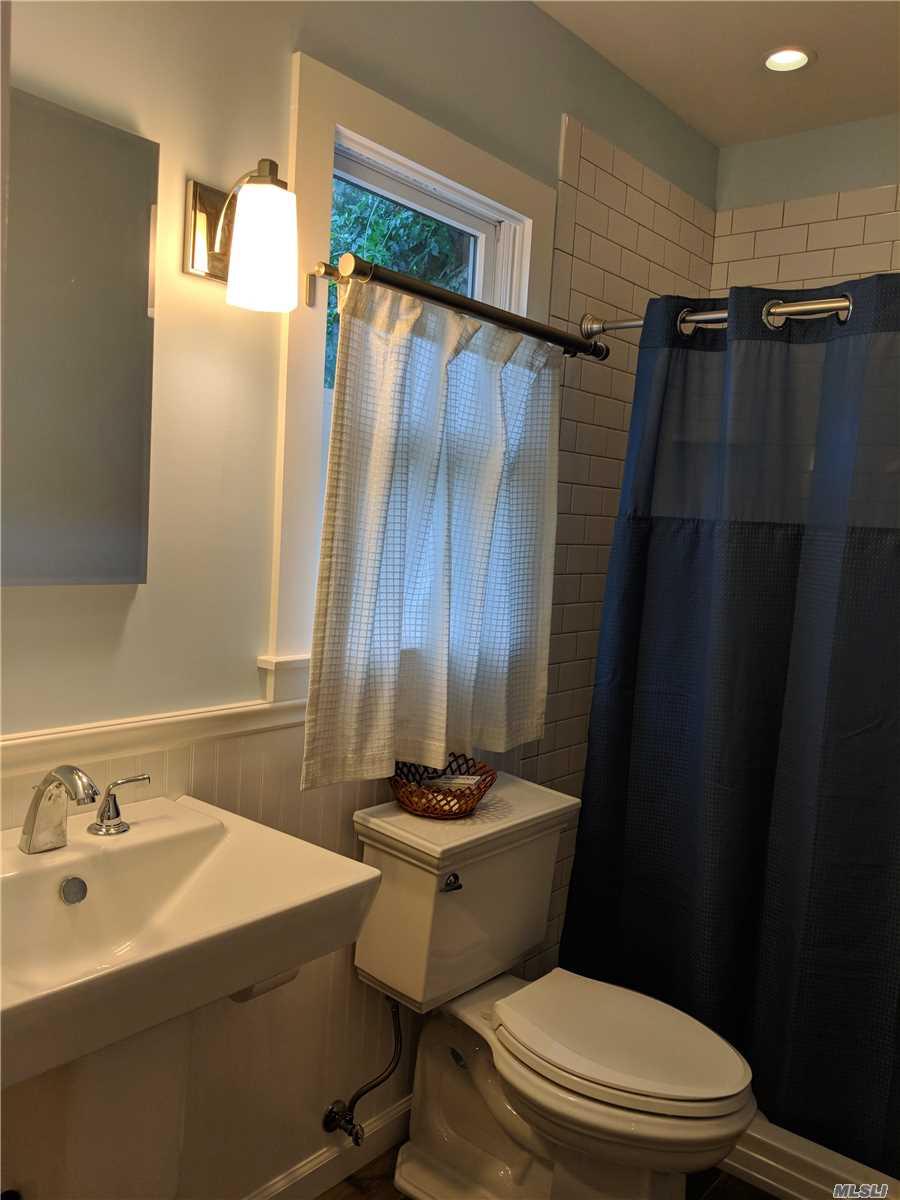 16640 Main Street, Unit COTTAG New Suffolk, NY 11956 - Photo 7 of 11 a bathroom with a sink toilet and shower