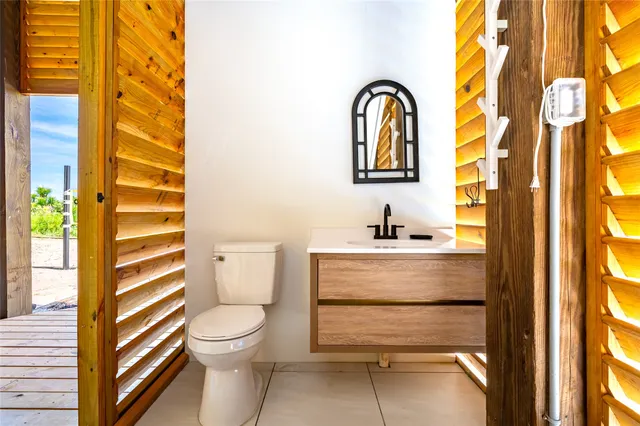 a bathroom with a sink a toilet and a window