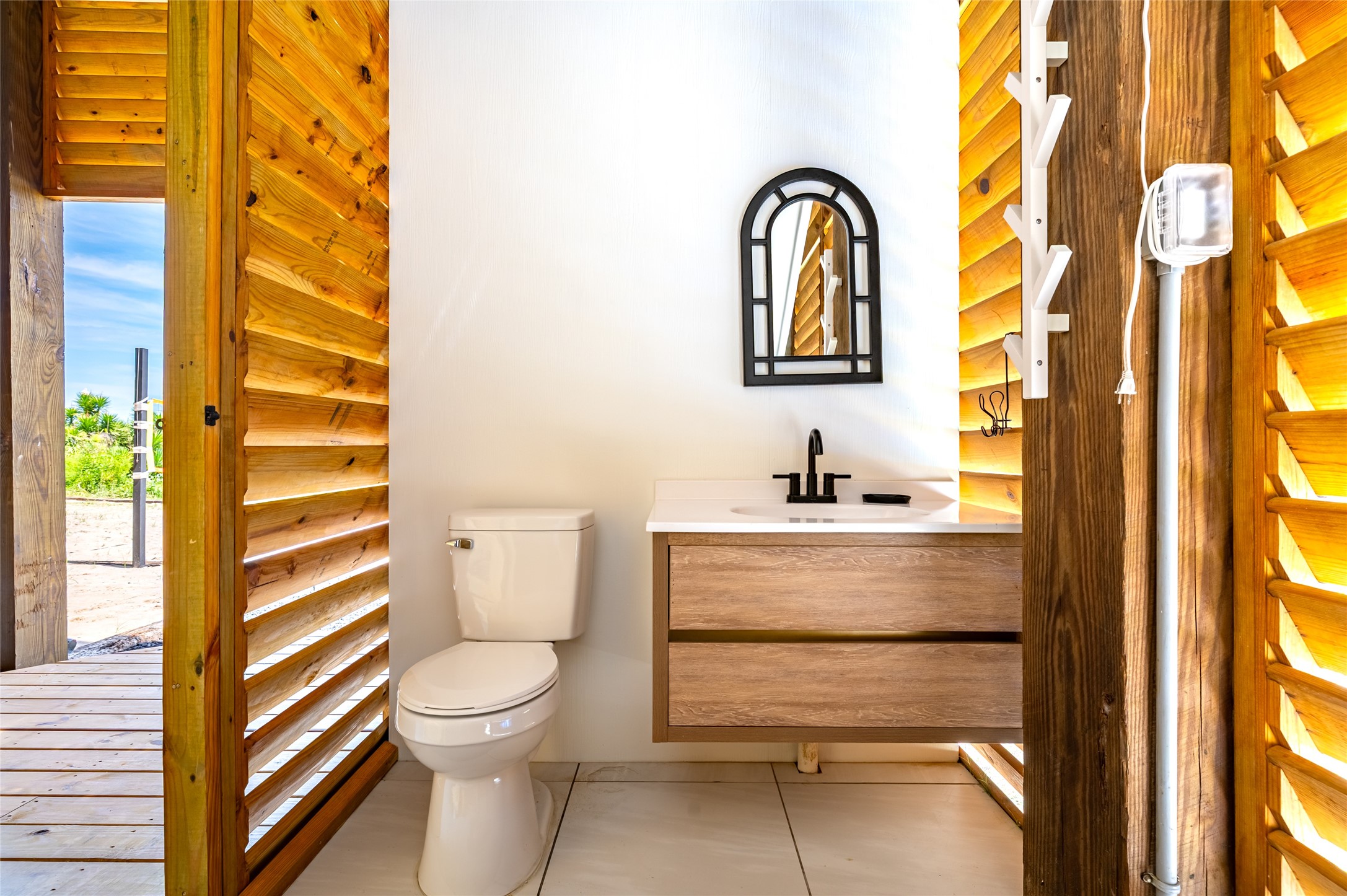 342 Atkinson Street Crystal Beach, TX 77650 - Photo 14 of 50 a bathroom with a sink a toilet and a window