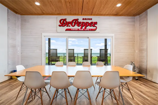 a view of a dining room with furniture wooden floor and chandelier