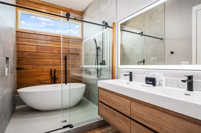 a spacious bathroom with a bathtub and shower