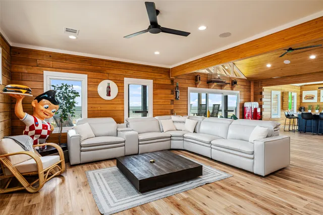 a living room with furniture ceiling fan and a rug