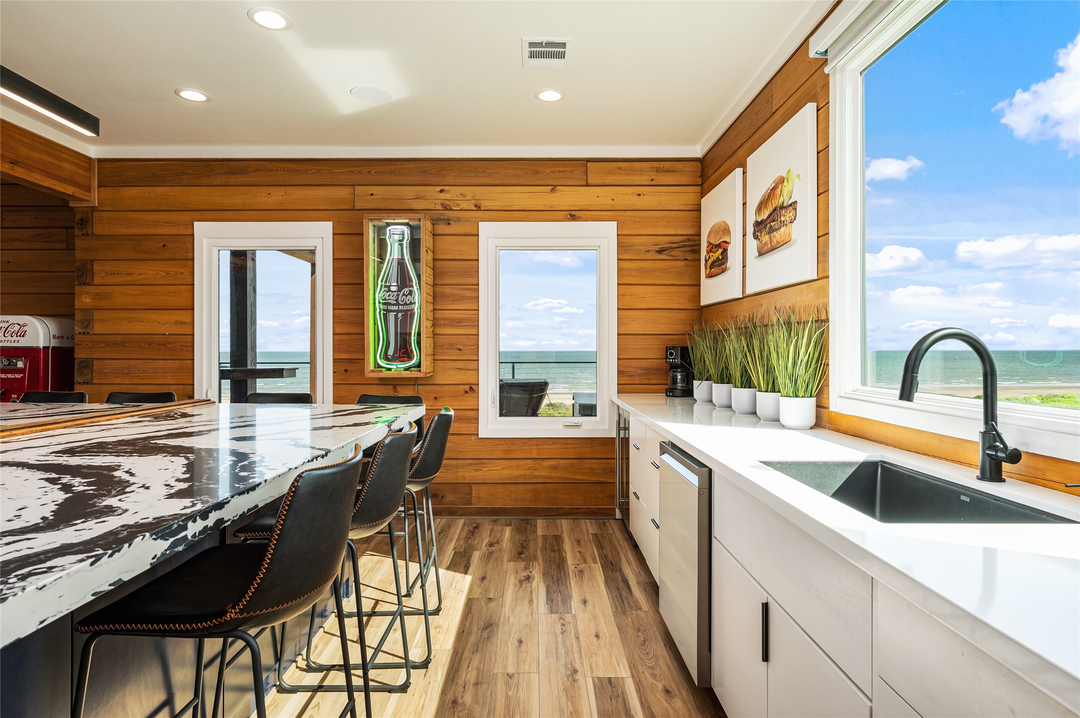 342 Atkinson Street Crystal Beach, TX 77650 - Photo 44 of 50 a large kitchen with kitchen island a stove a sink and cabinets