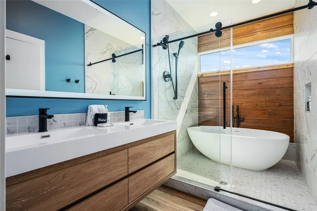 a bathroom with a double vanity sink mirror and shower