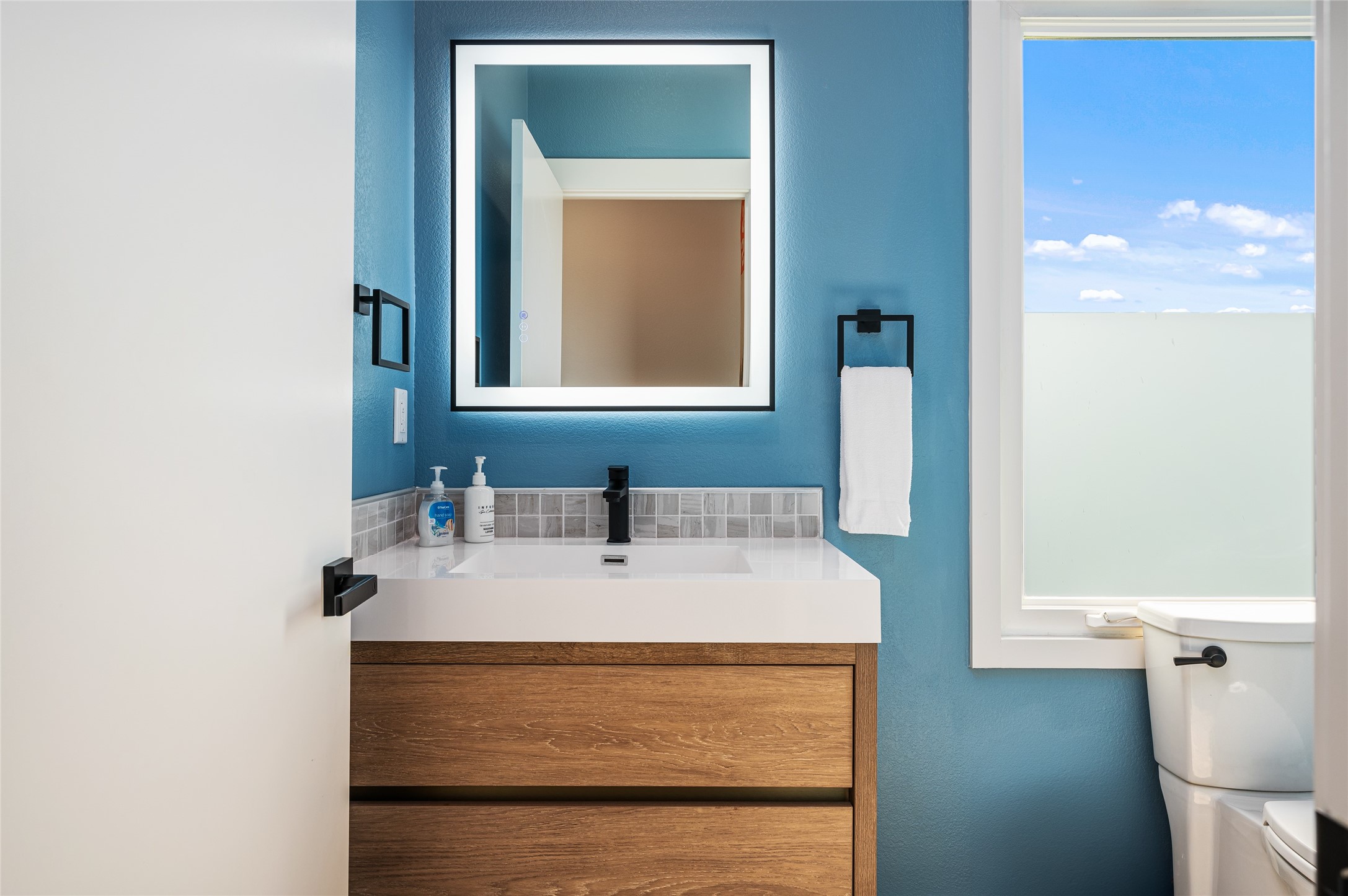 342 Atkinson Street Crystal Beach, TX 77650 - Photo 49 of 50 a bathroom with a sink and a mirror