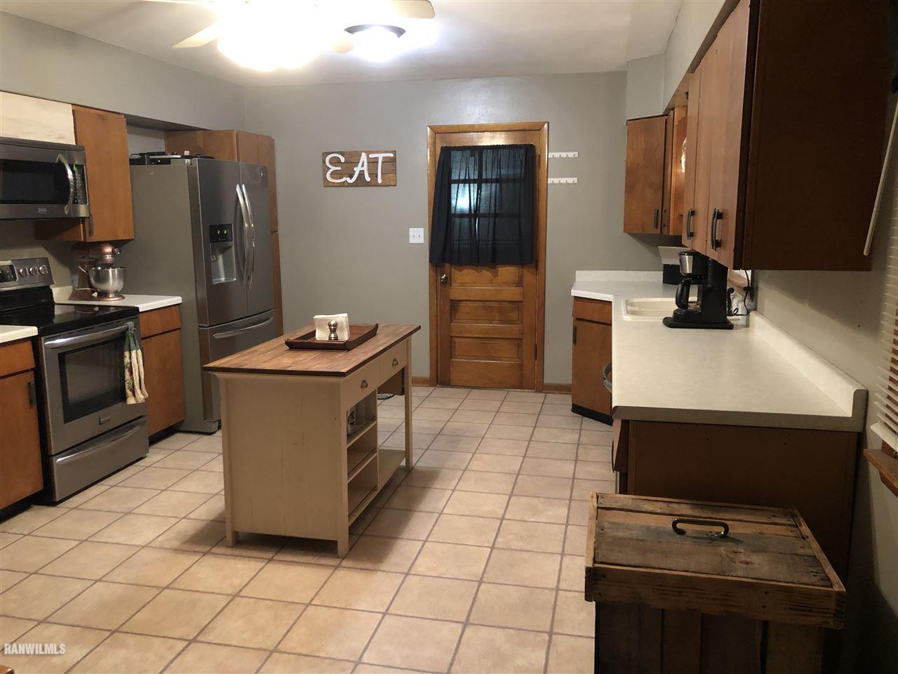 1883 East Currier Road Freeport, IL 61032 - Photo 3 of 36 a kitchen with stainless steel appliances a stove a sink and a refrigerator