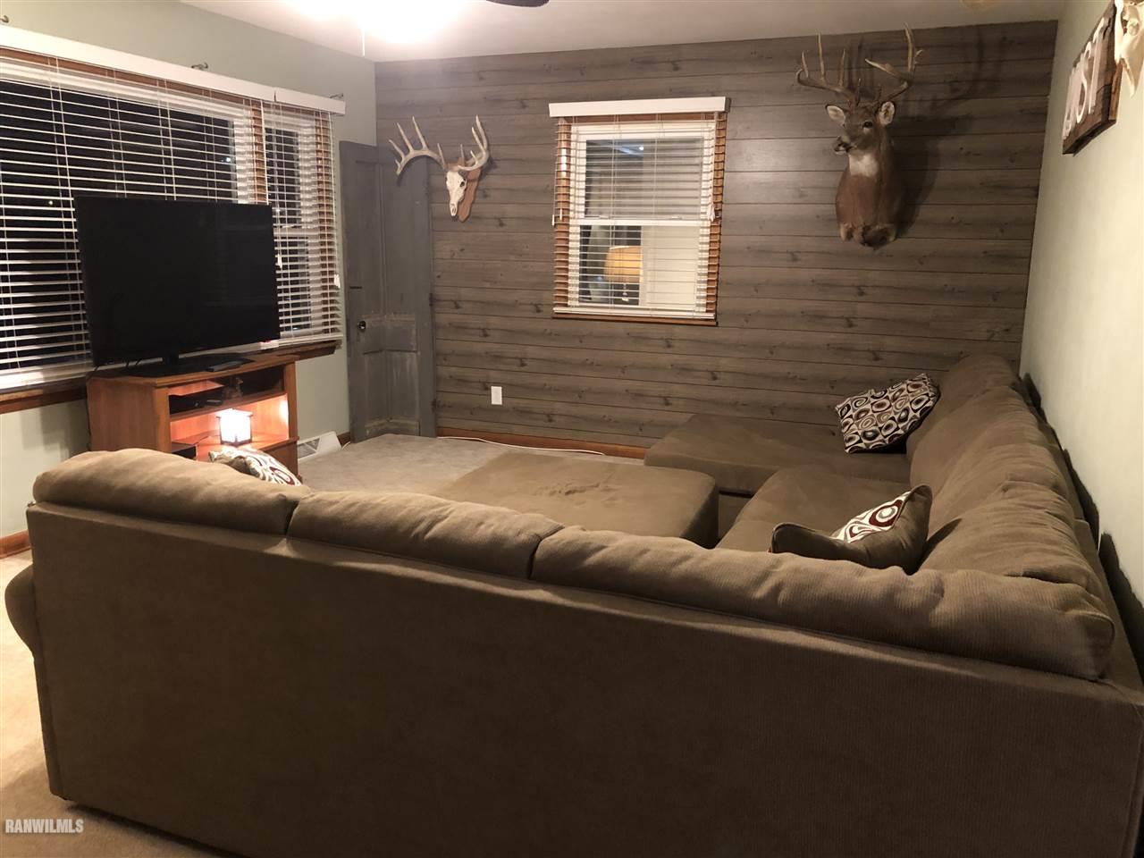 1883 East Currier Road Freeport, IL 61032 - Photo 9 of 36 a living room with furniture and a flat screen tv