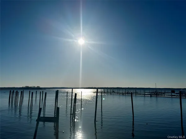 an empty room with windows and fireplace