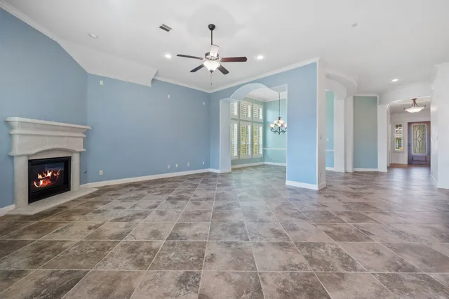 a view of an empty room with window and fireplace