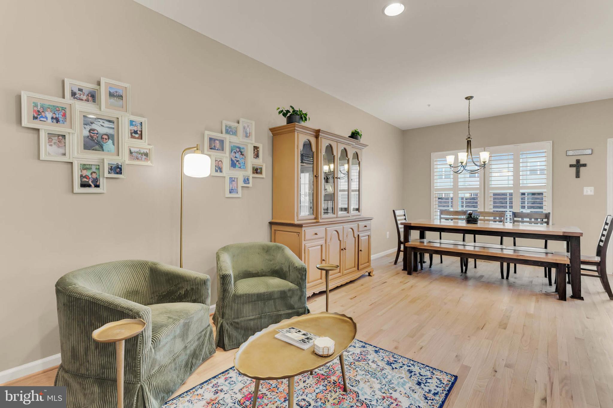 6367 Walcott Lane Frederick, MD 21703 - Photo 11 of 43 a living room with furniture a dining table and a wooden floor